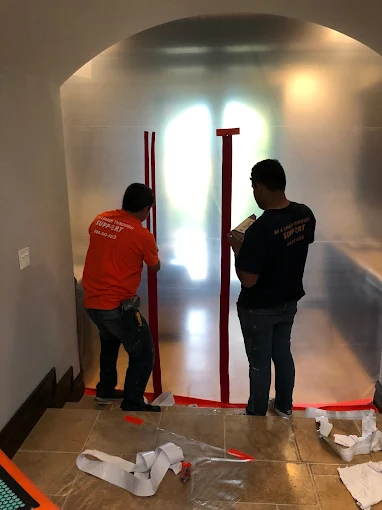 C&A Roofing water restoration technicians working on emergency water damage cleanup with professional equipment