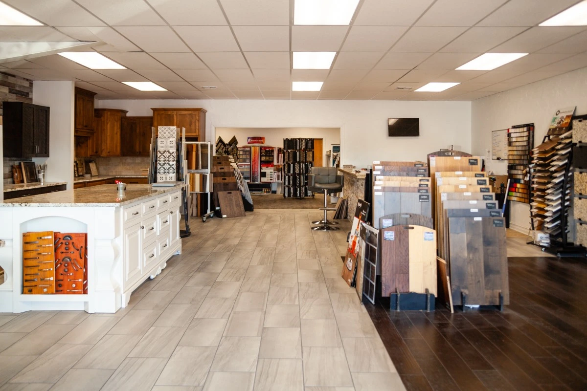 C&A Roofing & Construction flooring showroom displaying hardwood, tile, and luxury vinyl options
