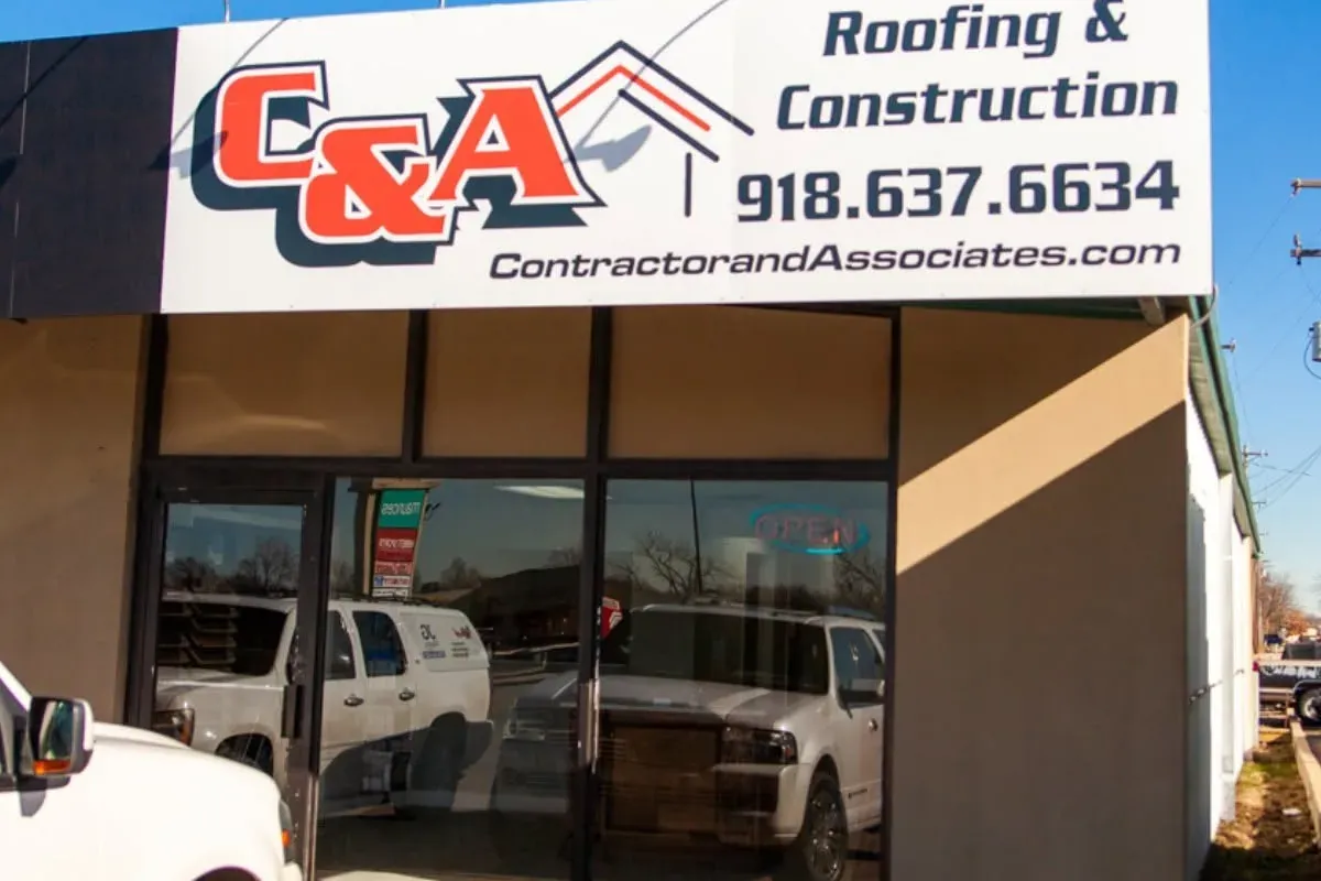 C&A office storefront with large sign and phone number, C&A Roofing & Construction