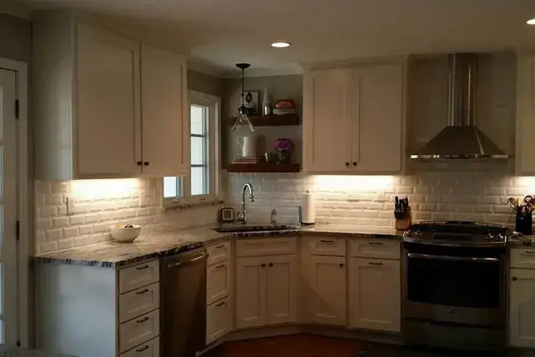 Finished kitchen with pale cabinets and dark counters, C&A Roofing & Construction