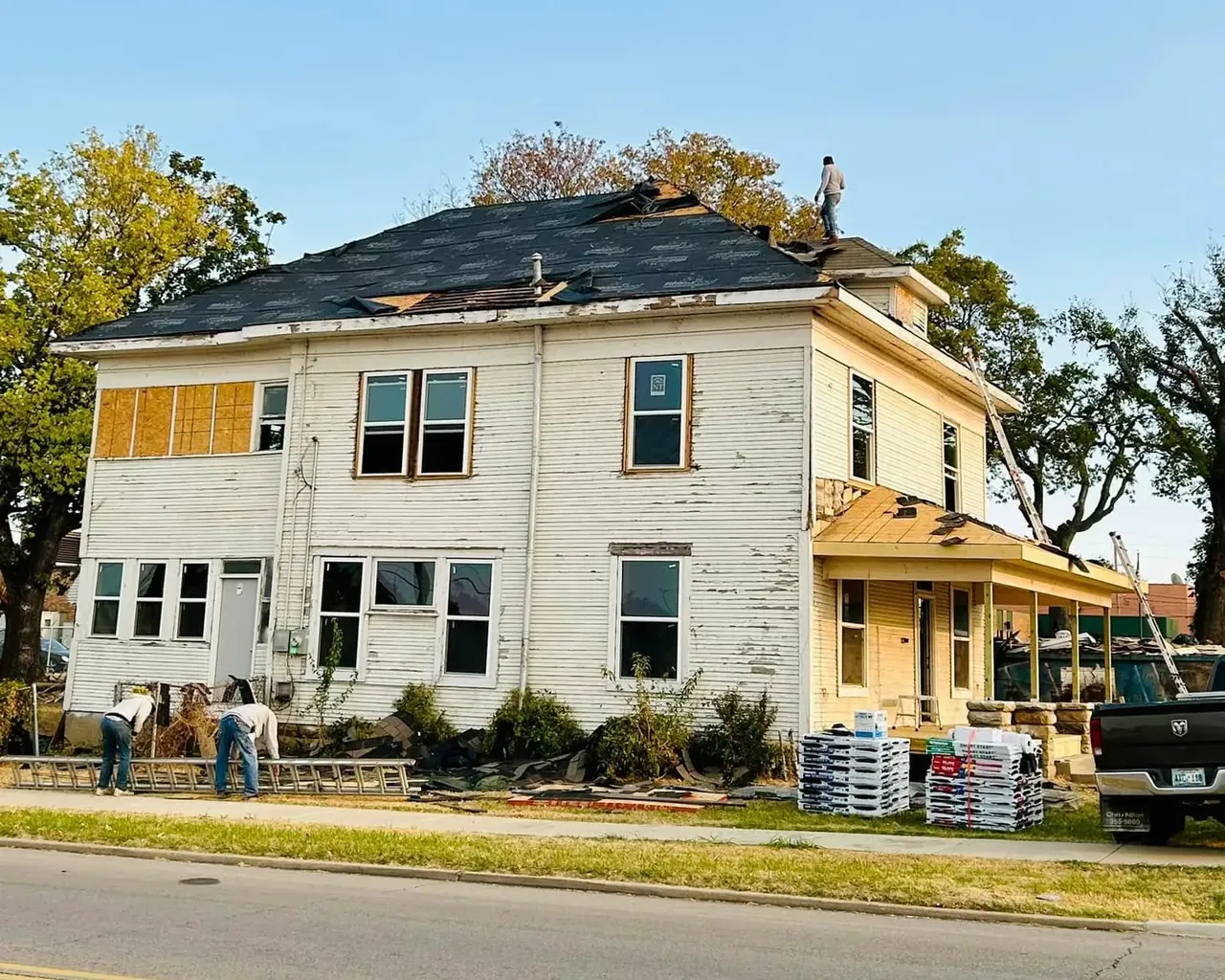 Two-story house undergoing roof installation, C&A Roofing & Construction