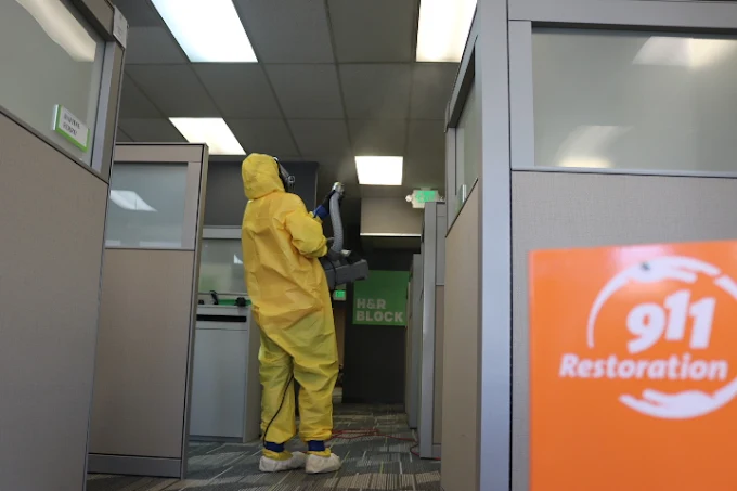 Professional restoration technician in protective gear